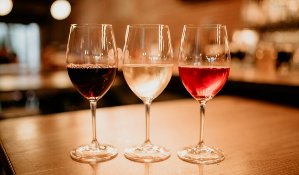 Hire a sommelier — red, white and rosé wine glasses on a tasting table