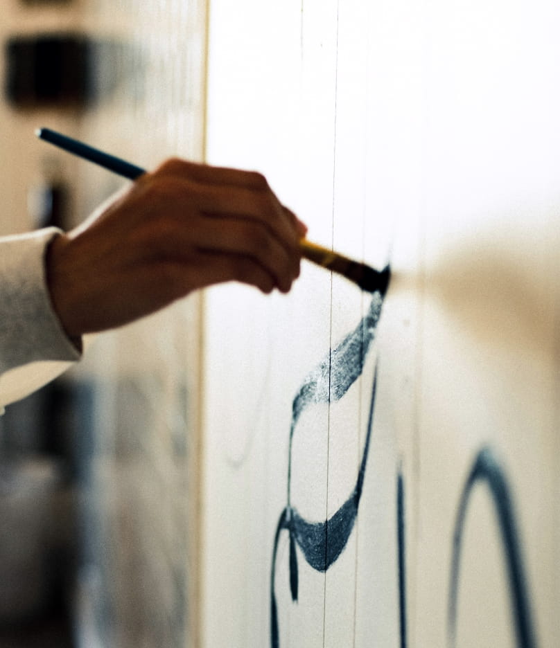 Artist painting a commissioned brushstroke artwork