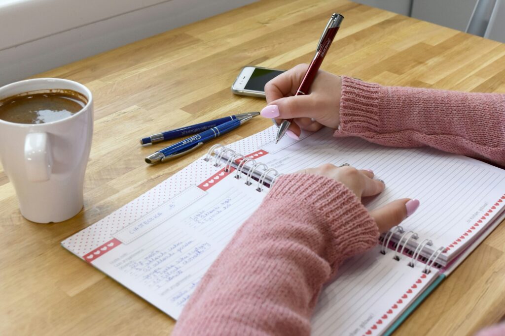 A personal assistant organising a household calendar in a planner