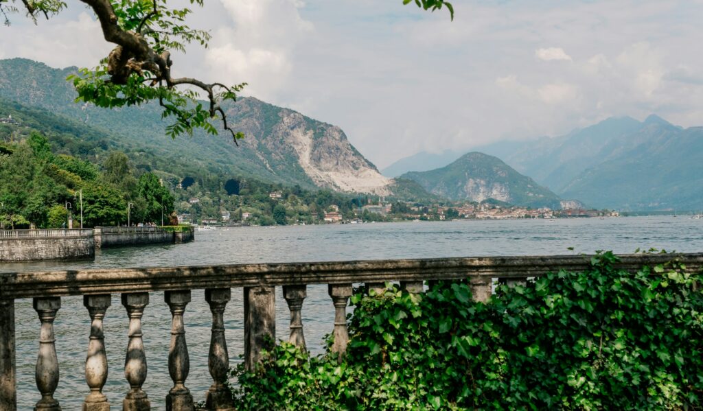 Luxury hotels Lake Como: a stone balustrade terrace overlooking the water and the mountains