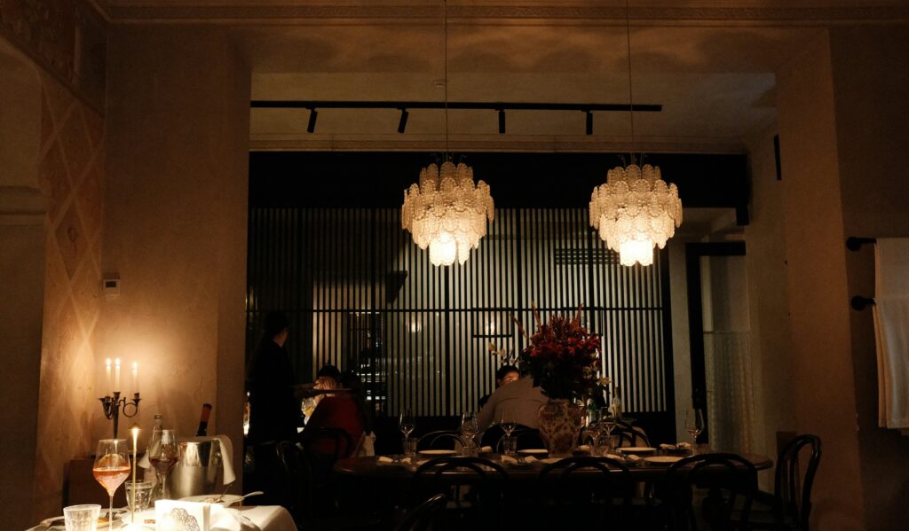 Candlelit dining room with crystal chandeliers, the kind of room found among the Michelin star restaurants Chicago is known for
