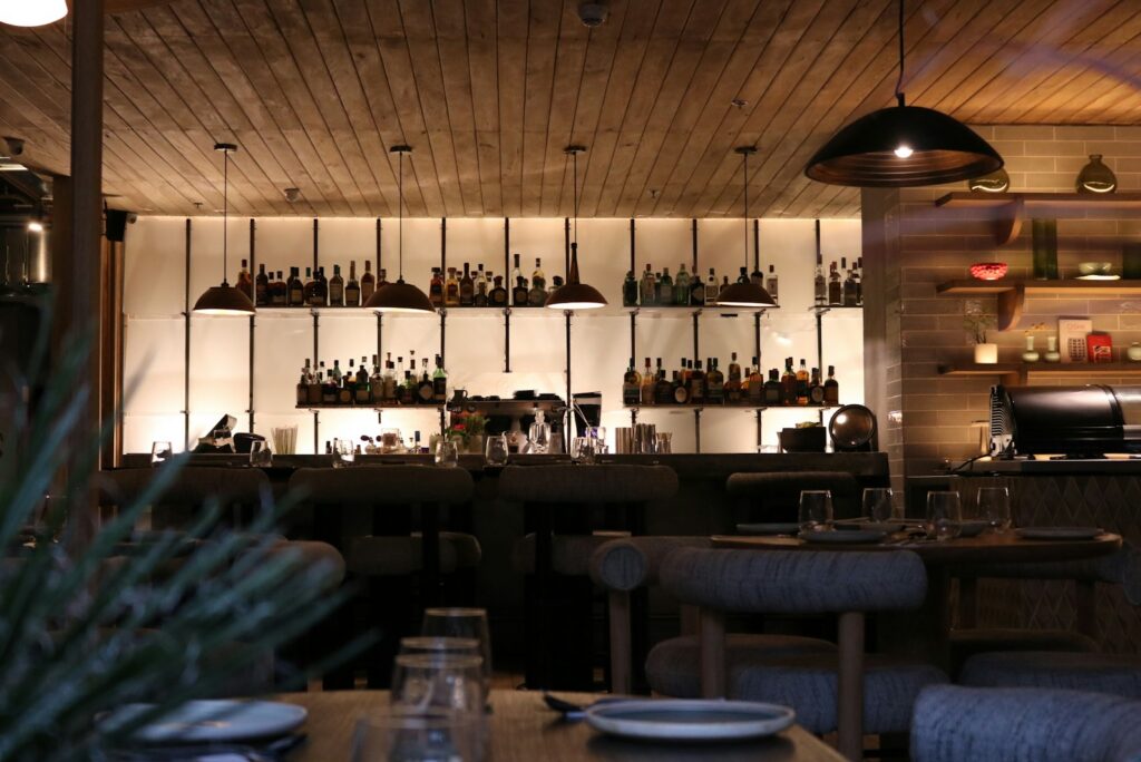 Warmly lit Copenhagen dining room with a bar and pendant lamps