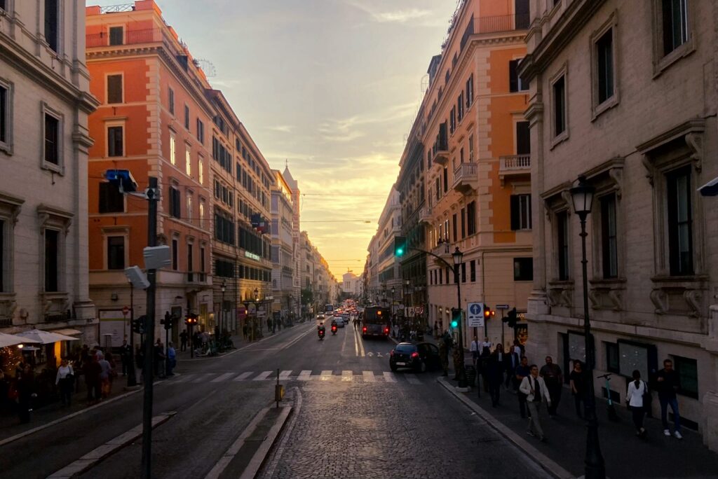 Rome street lined with ochre buildings at sunset
