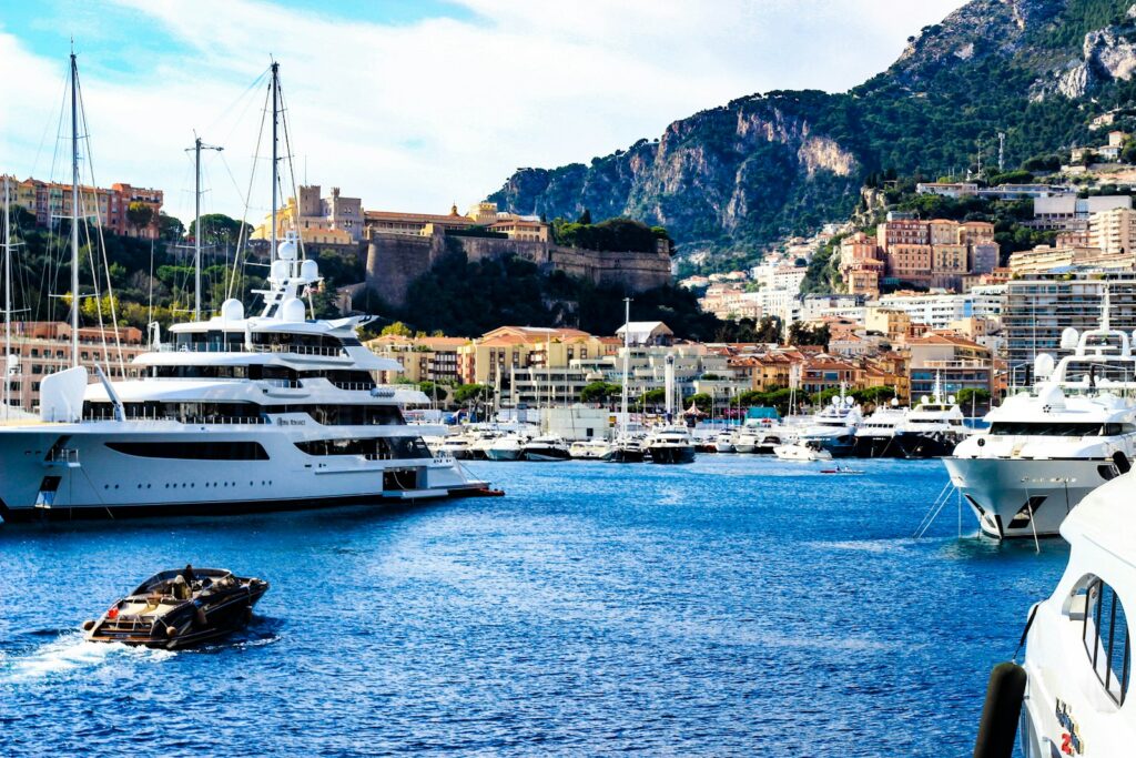Superyachts moored in Monaco harbour beneath Monaco-Ville