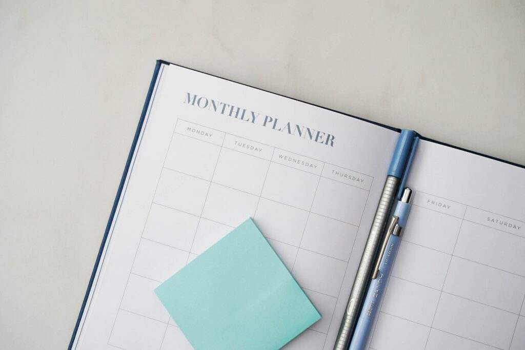 A monthly planner with a pen and a sticky note, used for a profiling interview