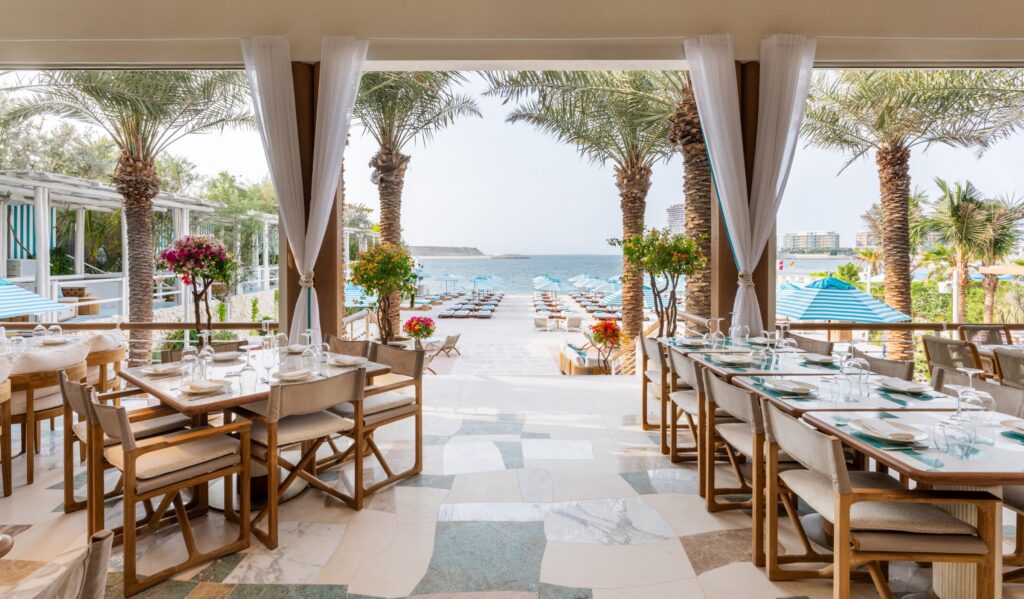 Nammos Dubai terrace at Four Seasons Jumeirah Beach, set tables looking out over the beach and the sea