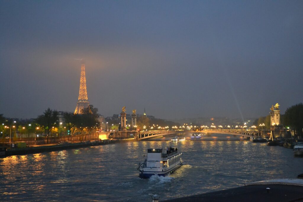 A boat on the Seine at dusk with the Eiffel Tower in the distance