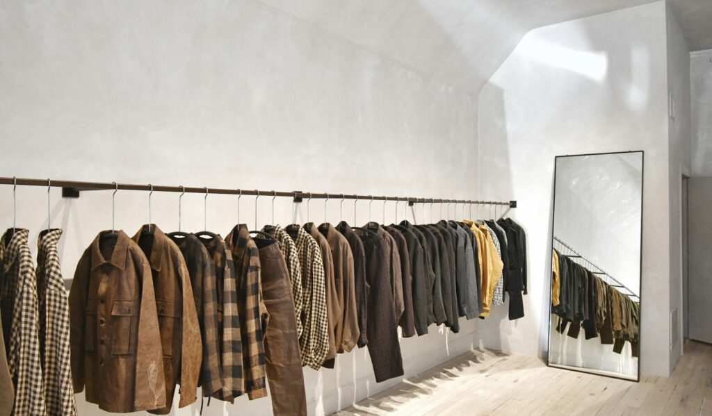 Personal shopping service: a pre-selected edit of jackets on a rail beside a mirror in a private white fitting space