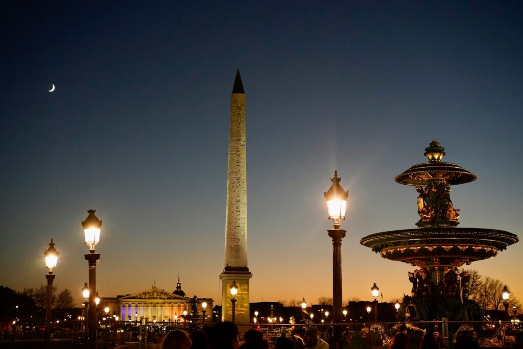 Obelisk and fountain of the Place de la Concorde in Paris at dusk