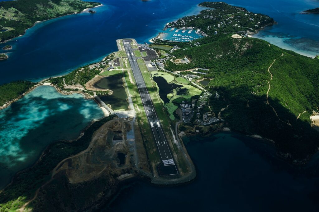 A small island airstrip surrounded by turquoise reef water