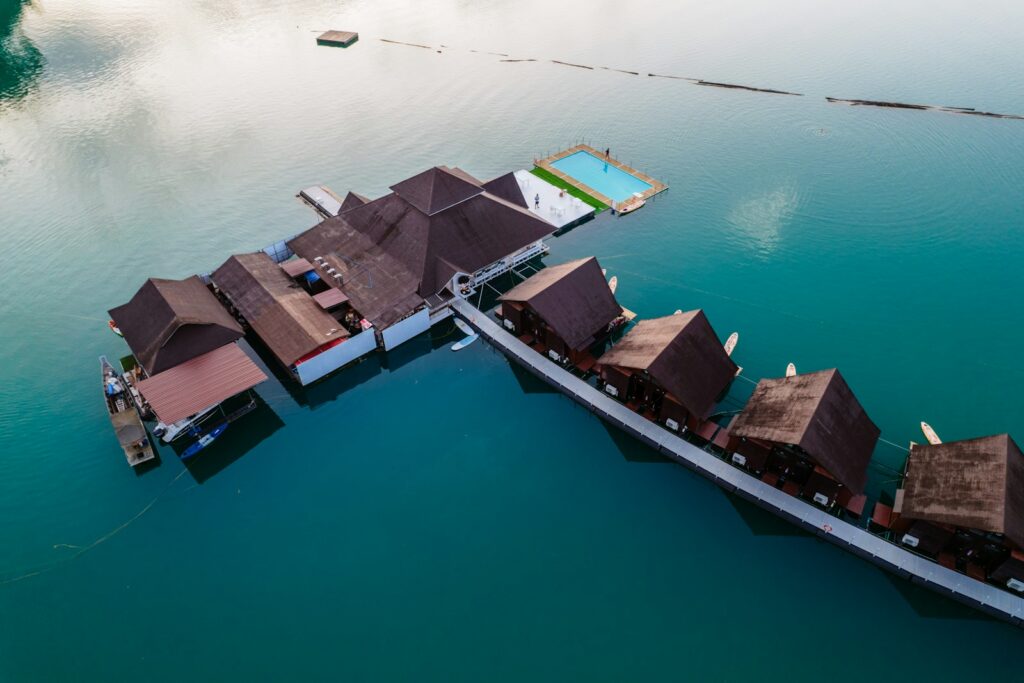 Overwater private island villas linked by a wooden jetty with a private infinity pool