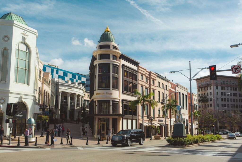 A domed corner building on Rodeo Drive in Beverly Hills beneath a bright sky