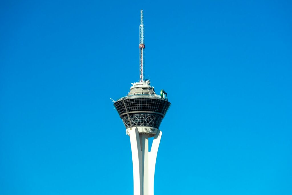 The Strat observation tower and its revolving pod against a clear blue sky