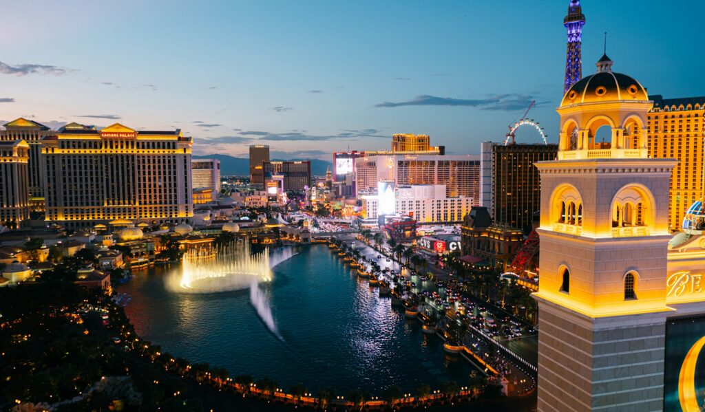 The Las Vegas Strip at dusk, with the Bellagio lake and resort towers, the view behind rooftop bars Las Vegas