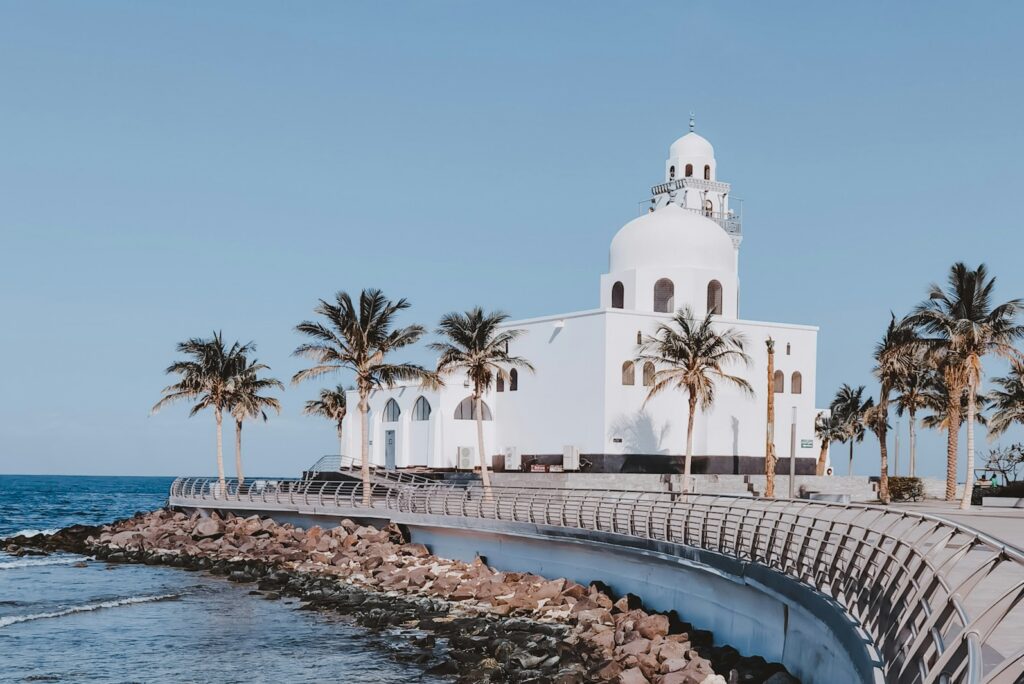White mosque with palm trees on the Jeddah Corniche beside the Red Sea.