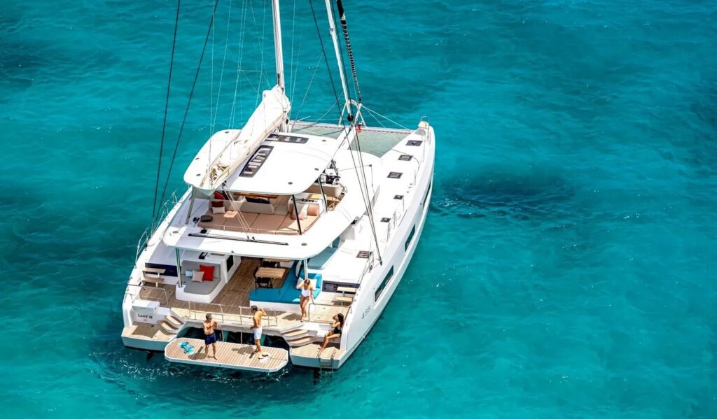 Premium catamaran at anchor in a quiet bay during a crewed catamaran charter