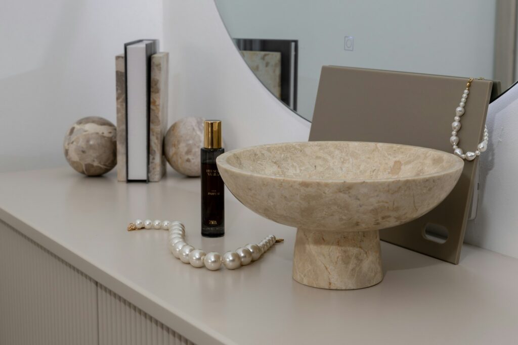 A pearl necklace and perfume bottle styled for a gift