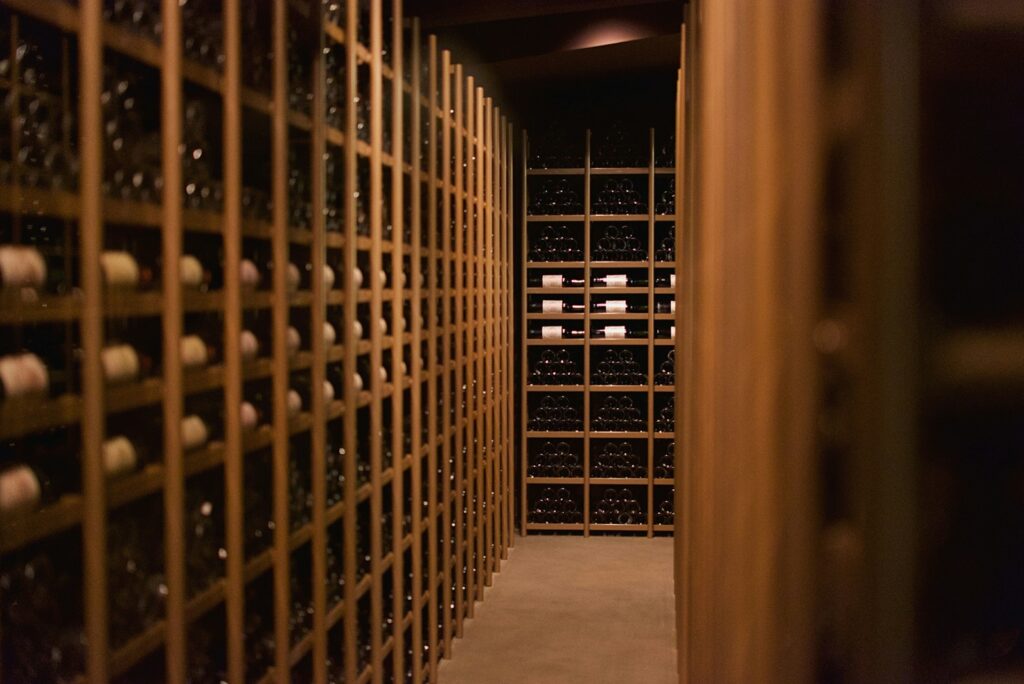 Private wine cellar with wooden racks of bottles