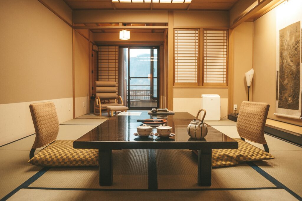 Traditional Japanese dining room with a low lacquer table, floor seats, tatami mats and a tea set
