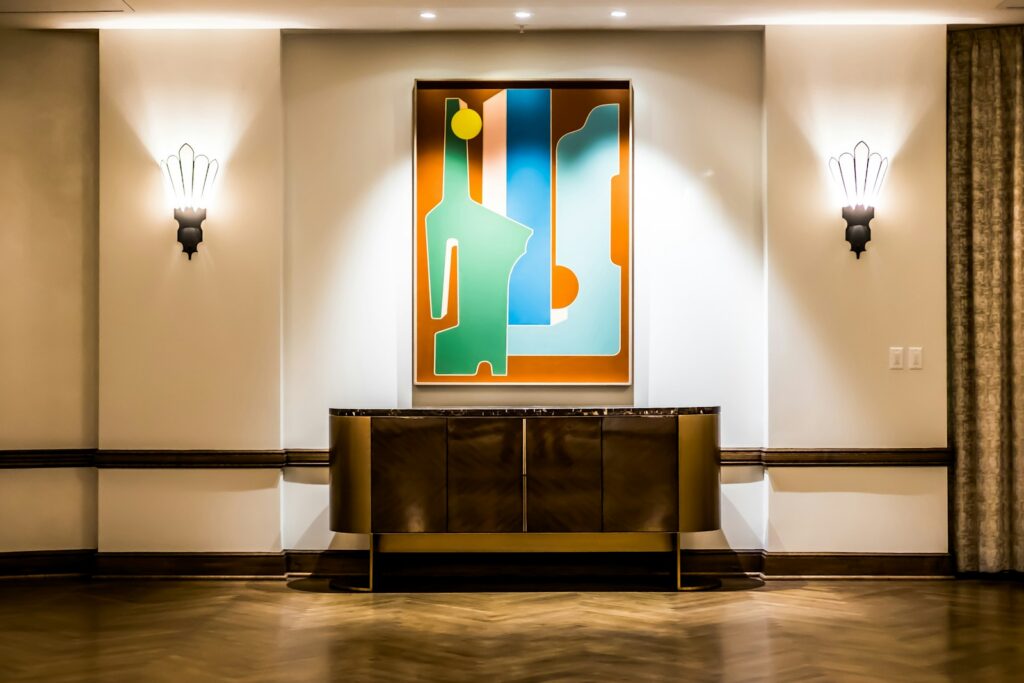 A quiet hotel corridor with soft wall lighting and no visible guests