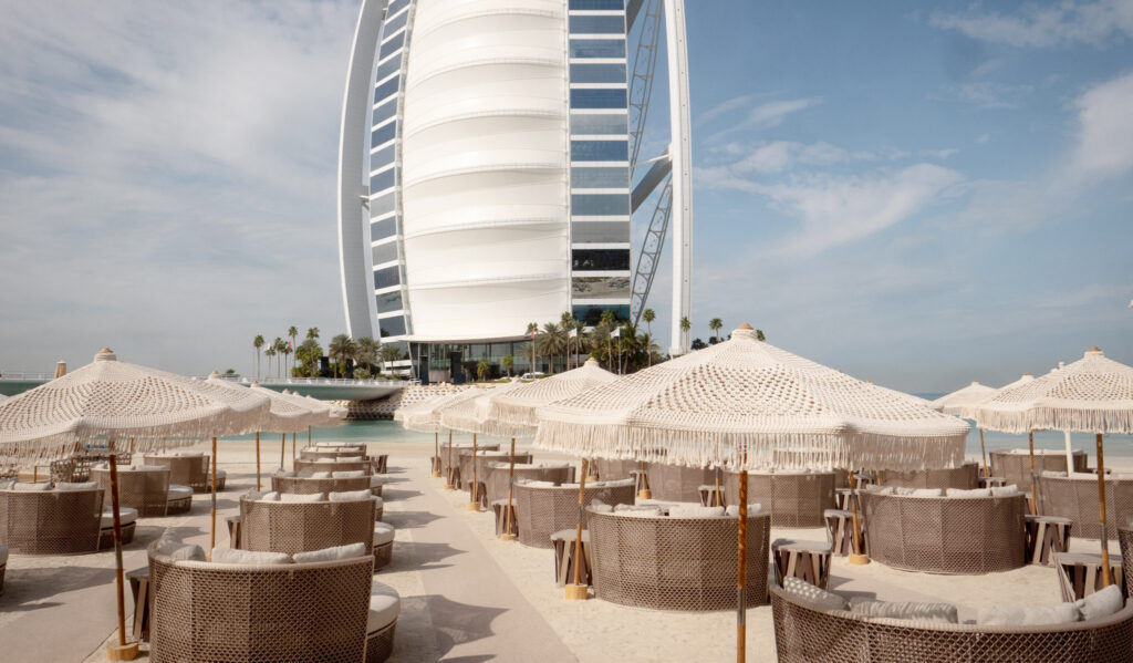 Verde Beach Dubai lounge seating and umbrellas facing the Burj Al Arab