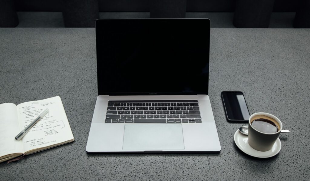 VIP concierge services — a phone, notebook, and coffee on a calm desk