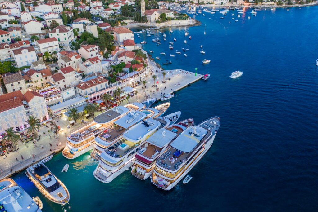 Aerial view of Hvar harbour with motor yachts moored along the quay