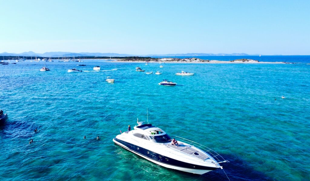Crewed yacht at anchor in clear water off Ibiza, a typical yacht charter Ibiza setting