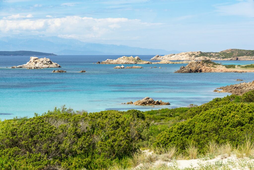 Turquoise water, small granite islands, and green coastal scrub in the La Maddalena archipelago